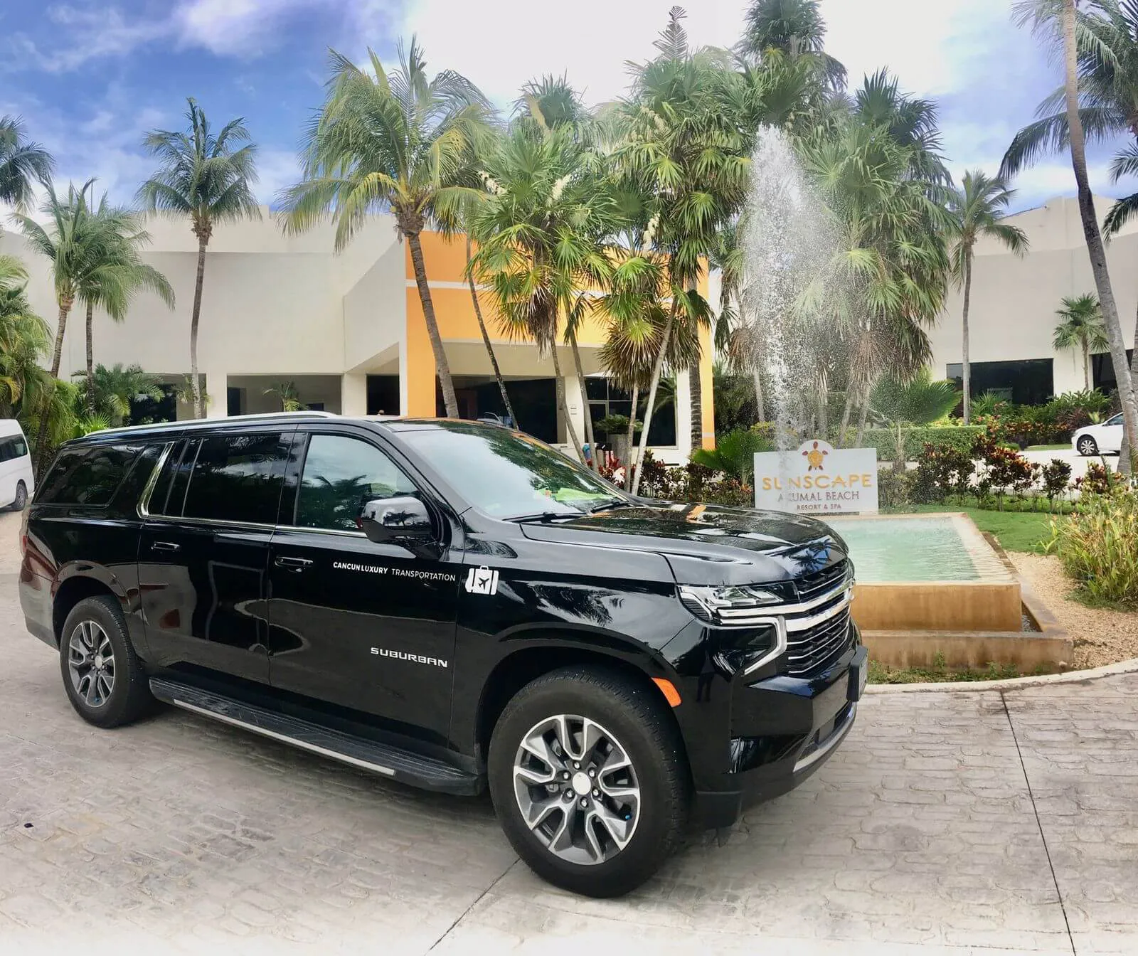 Luxury Transportation parked in front of Sunscape Akumal water fountain