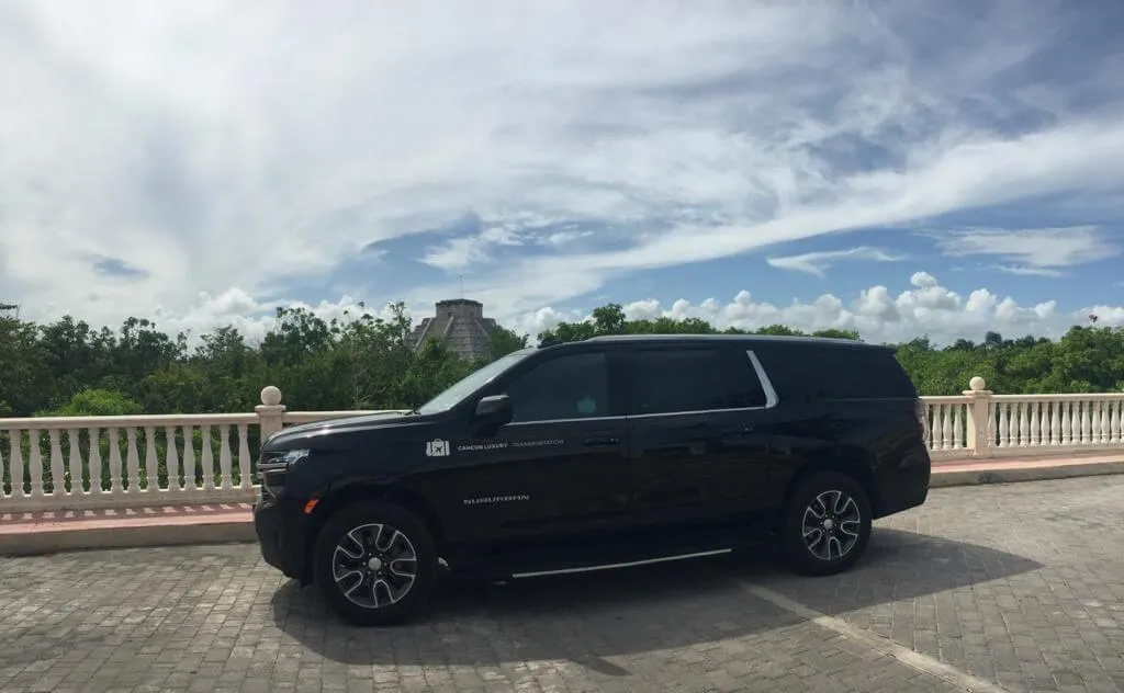 White luxury SUV parked by golf course