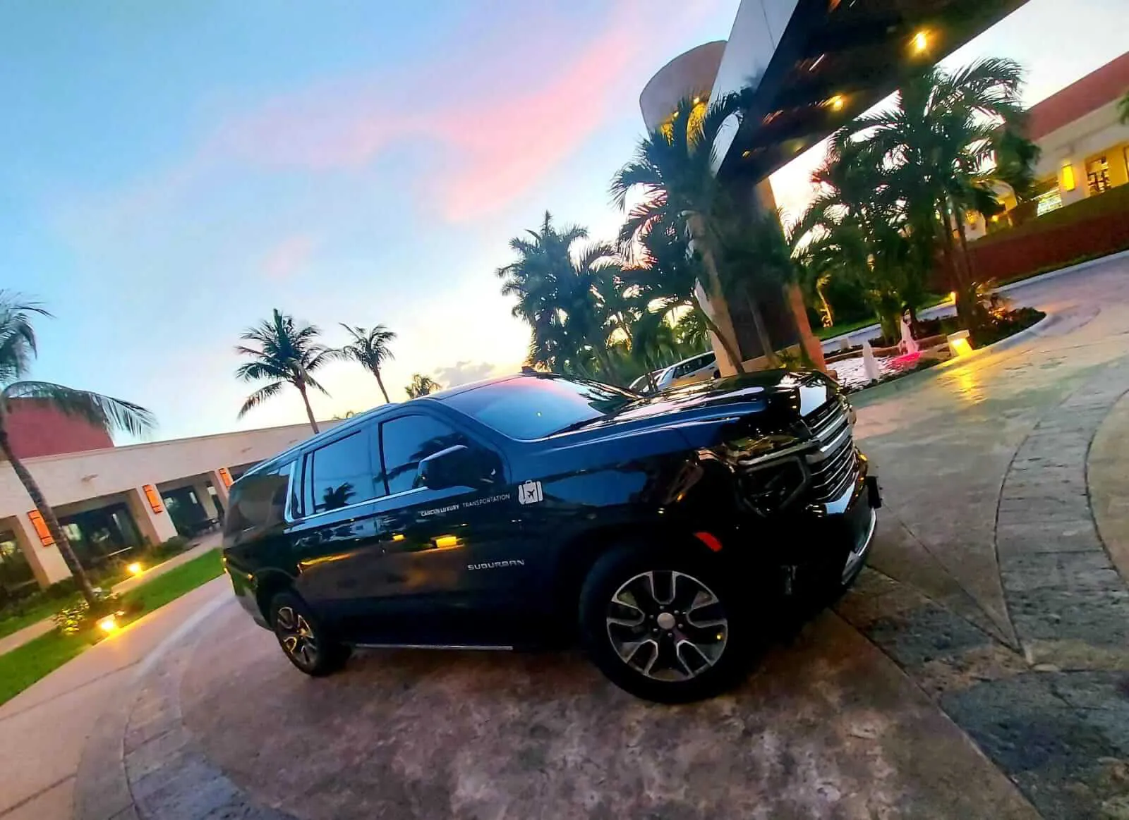 Luxury black SUV parked at hotel lobby