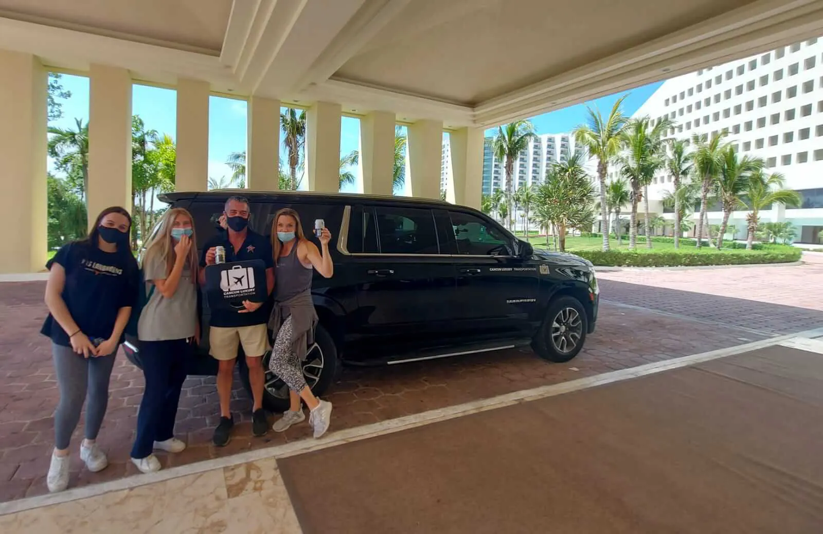 Family of four arriving at Cancun Hotel Zone by luxury transportation