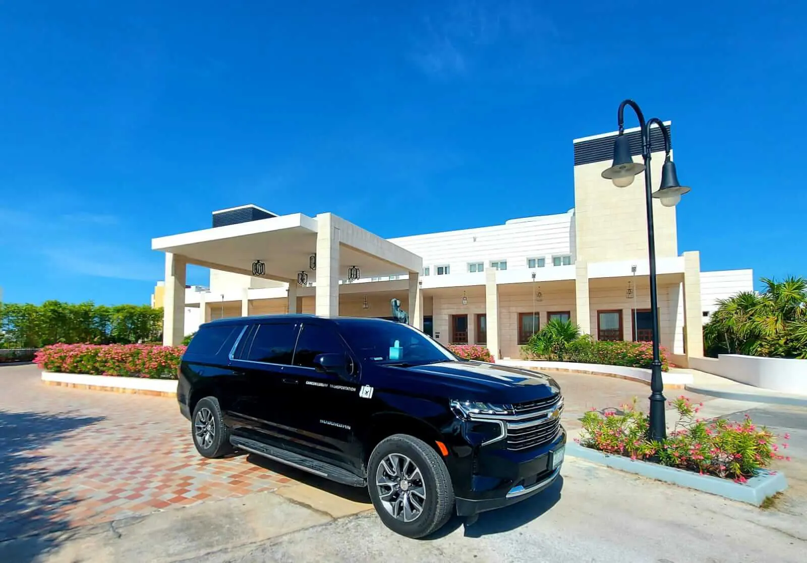 Luxury Suburban 2021 parked in front of hotel lobby
